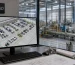 Factory layout design services shown on a CAD workstation overlooking a coordinated manufacturing floor